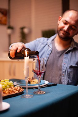 Koca şarap dolduruyor.