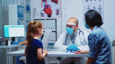 Çocuk sıcaklığını ölçen uzman doktor.