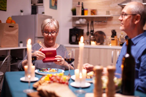 Rentnerin hält Geschenkbox in der Hand — Stockfoto