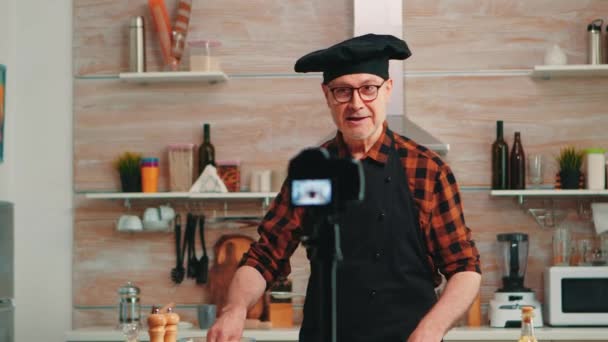Portrait of positive chef recording vlog in kitchen — Stock Video