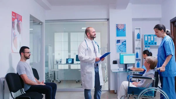 Young doctor talking with disabled woman