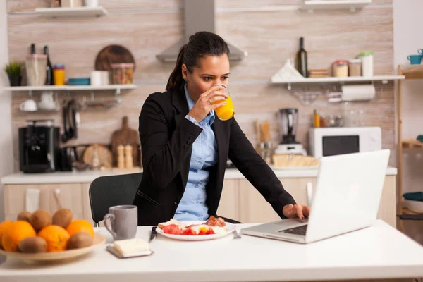 Frühstück essen und Laptop benutzen — Stockfoto