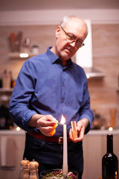 Happy senior husband using matches — Stock Photo, Image