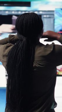 Vertical video Woman embraces abundance of video content displayed on digital wall dashboard, exploring entertainment channels. User amazed by immersive streaming platform delivering nonstop videos