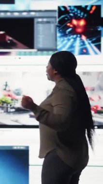 Vertical video User enjoying watching unlimited video streaming service content library on dynamic media wall filled with viral clips. Woman living entertainment focused digital age lifestyle, camera