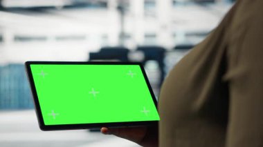 Server room admin uses isolated screen tablet to increase supercomputers workload capacity. Data center worker configures gear with chroma key device notebook, improving processing speed, camera B