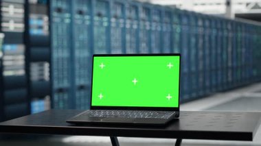Isolated screen laptop in data center used for doing maintenance on infrastructure, improving workload. Chroma key notebook in server farm used by high tech server clusters for parallel processing
