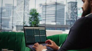 Determined CEO works in office analyzing infographics and setting business goals to drive corporate growth, global investment strategy in a competitive environment. Leadership skills. Camera A.