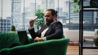 Male leader in a smart office thinking about ways to increase business profit, showcasing productivity while he manages company investments. Chief executive officer in office. Camera A.