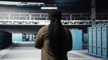 Data center software developer using deep learning tech to optimize operations. Server hub worker oversees specialized equipment accelerating complex artificial intelligence calculations, camera A