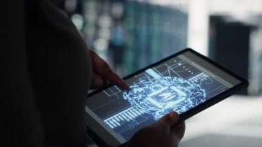 Close up of data center technician doing AI data analysis on tablet to upgrade infrastructure. Server room employee using device to manage storage systems for machine learning training datasets