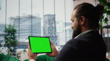 Smart businessman in office makes business projections next to copy space, reviews profitability reports and executes investment strategies for sustained corporate growth. Success story. Camera A.