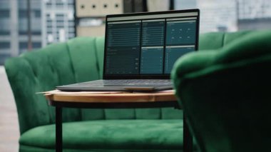 Empty urban corporation high end office designed for a leader, showcasing laptop with analytics and profit trends on screen. Modern global corporation workspace, business success.