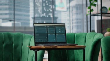 Big data reports and graphics showcasing business corporation success, empty luxurious office with a laptop on the table. Professional workspace with pc display running trends.