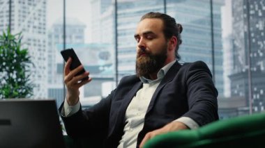Director engaging in an executive phone call discussion with a financial broker, sharing insight on market forecasts and investment strategy, demonstrating his eye for business ideas. Camera B.