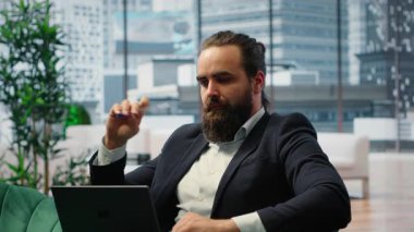 Male leader in a smart office thinking about ways to increase business profit, showcasing productivity while he manages company investments. Chief executive officer in office. Camera A.