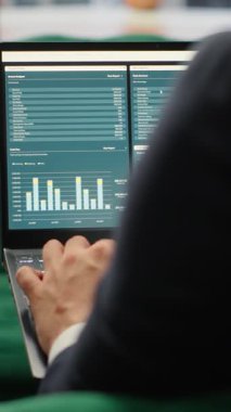 Vertical Video Visionary entrepreneur sits in a high end corporate workspace, focusing on investment planning and business development. Young CEO optimizing productivity to drive enterprise success