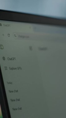 Vertical Video Bucharest, Romania - July 30th 2024 - Man uses futuristic AI chat on software to enhance productivity and efficiency in business operations. Chatgpt AI tool bot generating text. Camera