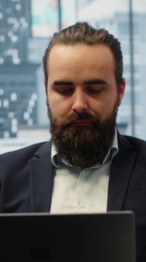 Vertical Video Goals oriented businessman focuses on his company and career development, analyzing reports and trends to ensure a success story in the competitive environment of business industry