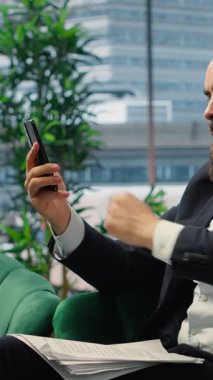 Vertical Video Rude furious director yelling at his partners on teleconference call, screaming and accusing them of incompetence. Aggressive irritated boss throwing documents around, difficult