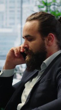 Vertical Video Business administrator struggling to negotiate over the phone, receiving a negative answer and being dissatisfied with himself. Displeased boss dealing with bad news and disappointment