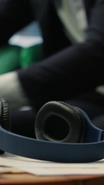 Vertical Video Young entrepreneur relaxing with breathing exercises and a mobile meditation app, working hard to reduce stress. Peaceful vibe showcases how mindfulness can enhance business growth