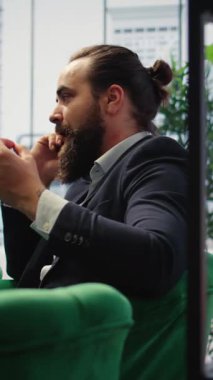 Vertical Video Unsatisfied irritated leader scolding his assistant on a telephone call, criticizing the ineffective team and showcasing incompetence in managing a corporation. Difficult relations