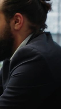 Vertical Video Male leader relaxes during a work break using sound healing to reduce stress. CEO with a calm and strong posture reflecting the power of meditation in a high performance company setting