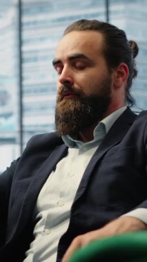 Vertical Video Director engaging in an executive phone call discussion with a financial broker, sharing insight on market forecasts and investment strategy, demonstrating his eye for business ideas