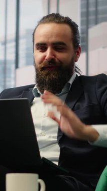 Vertical Video Empowered director sharing his goals and targets on teleconference call, discussing with the executive board members on video call about a potential loan. Leadership skills. Camera B.