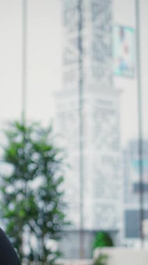 Vertical Video Young entrepreneur relaxing with breathing exercises and a mobile meditation app, working hard to reduce stress. Peaceful vibe showcases how mindfulness can enhance business growth