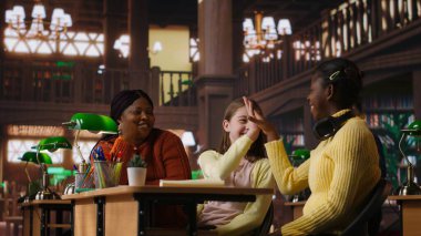 Özel seanslar sırasında çeşitli kızlara eğitim veren Afrikalı Amerikalı öğretmen, kütüphanede ödev ve okul projelerinde yardımcı oluyor. Başarı için özel ders veriyorum. Kamera B.