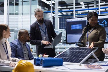 Scientists in solar technology lab doing research and development, experimenting with photovoltaic materials, focusing on increasing panel durability and efficiency for large scale solar farms