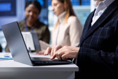 Anlaşmadan önce hissedarların kurallarına uymayı değerlendirmek için not defteri kullanan bir uyum memuru. Yatırım yapmadan önce mali durumları inceleyen, dizüstü bilgisayardaki fabrika yatırımcısı tipleri.