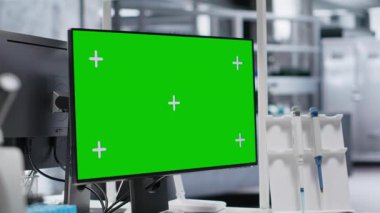 Boş laboratuvar alanındaki bir masada izole edilmiş bir maket bilgisayar, test araçları ve bilimsel aletler biyobilim araştırma ortamını yakalar. Tıbbi keşif ve tanı.