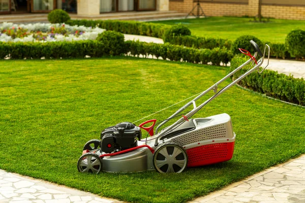 Lawn mower with grass — Stock Photo, Image
