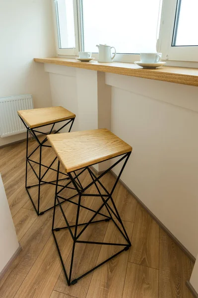 bar stools by the window with a bar