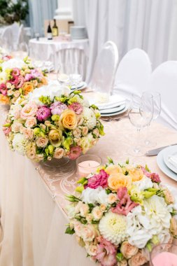 Çiçek vazosuyla süslenmiş masa.