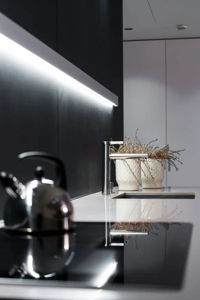 Kitchen area with kettle and stove