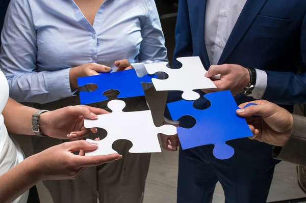 male and female hands with puzzles