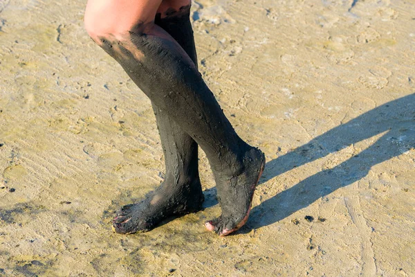 female feet in mud