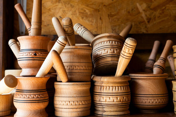 wooden mortar with pestle on a shelf