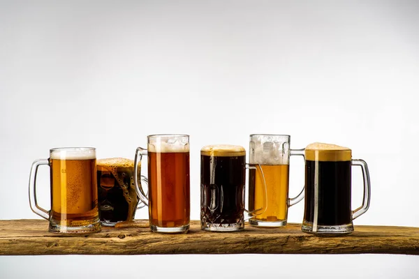 Glasses with beer of different varieties on a uniform white background, isolated objects