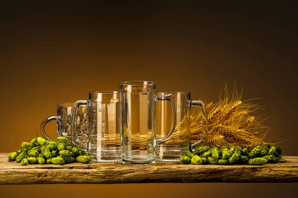 beer glasses with wheat and hops on the table