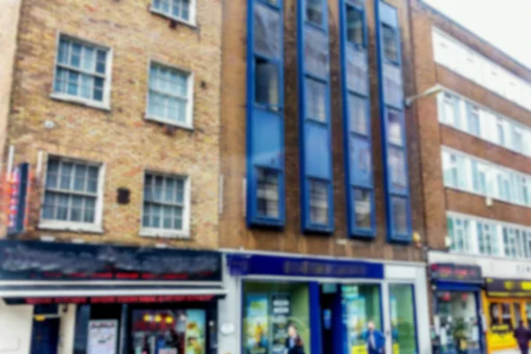 Small restaurant and others businesses and stores at one of old London street. Blurred view