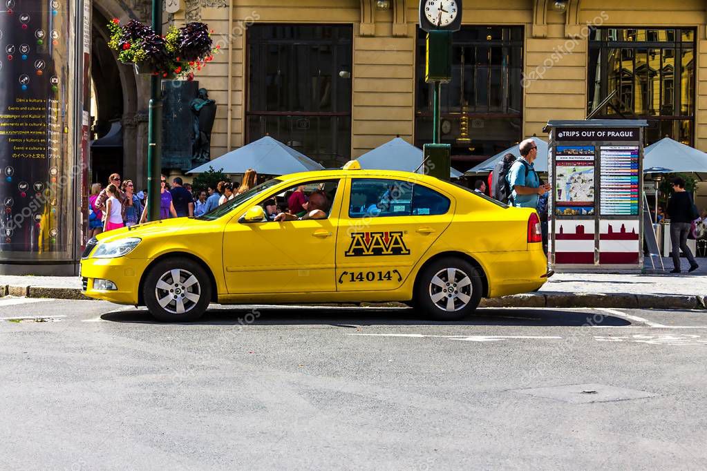 Prague, Czech Republic -July 23,2017: AAA taxi yellow Skoda cars wait for passengers on their cab rank on famous Republic square near Municipal House (Smetana Hall)
