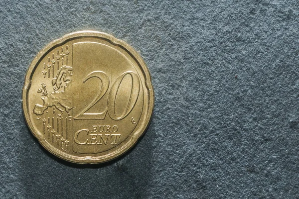 Twenty cent euro coin on a rock table