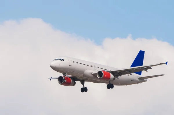 Airplane with lowered landing gear ready for landing