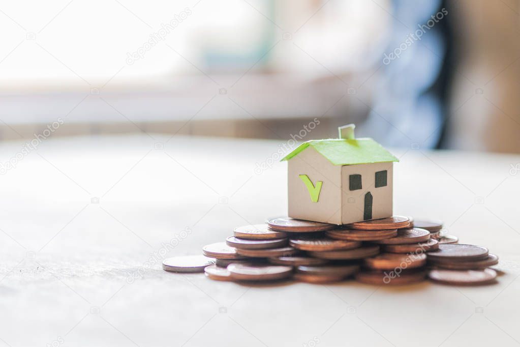 Mortgage and loan approved concept: paper house on a copper coin pile coin pile