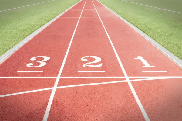 Numbers three two and one on a tartan running track